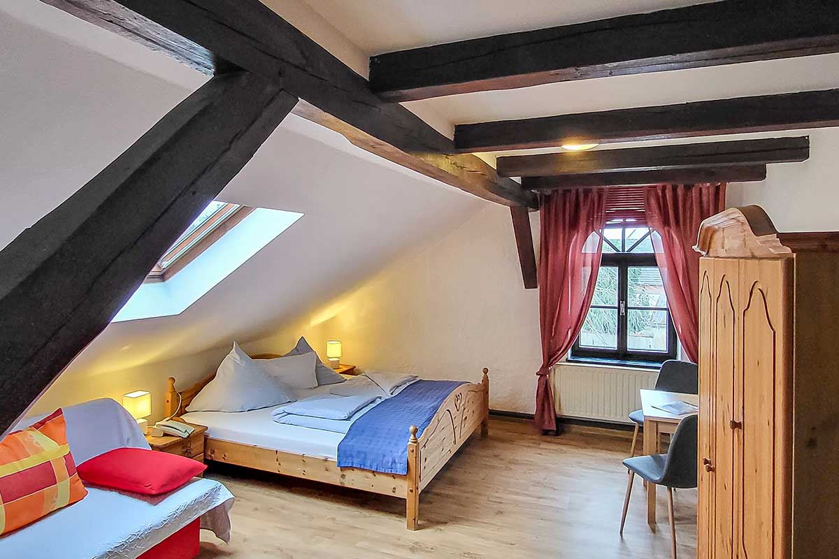 Room view of a double room at Hofschänke with wooden beam ceiling